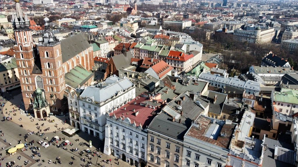 Aerial view of Gdańsk Marine Center on the Martwa Wisła with pontoons, travelift hardstand, and the Gdańsk shipyard cranes on the far bank.
